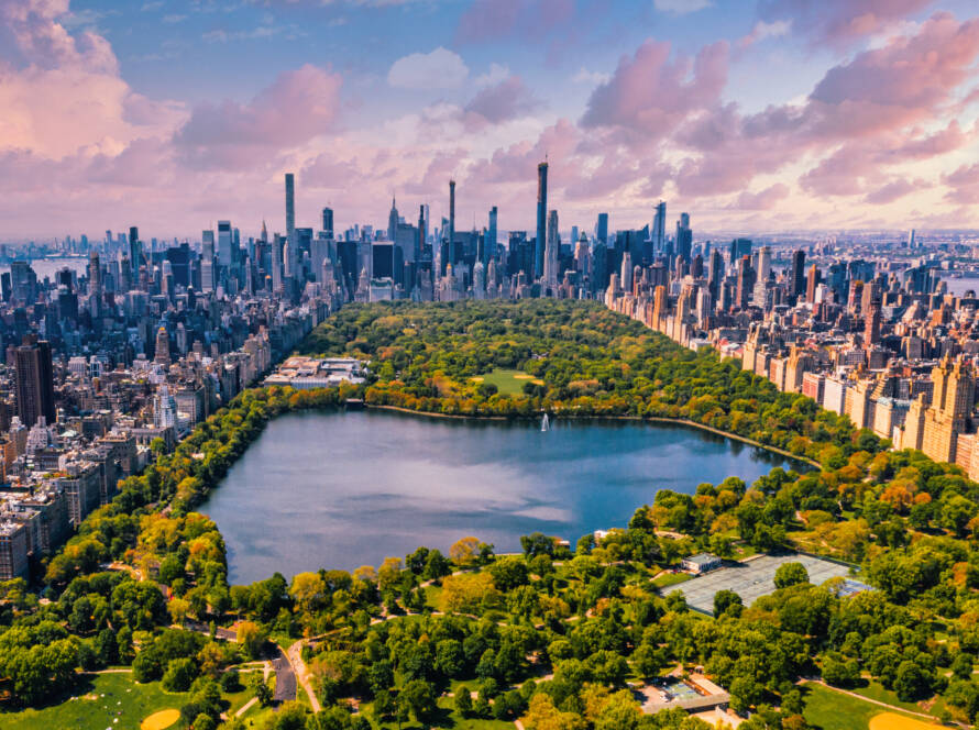 Central Park in Manhattan, New York, a huge beautiful park surrounded by skyscraper with a pond